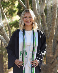Olivia Kjorlien, Strategic Communications Associate at Four Leaf Communications, pictured at her UW-Green Bay graduation with honor cords.