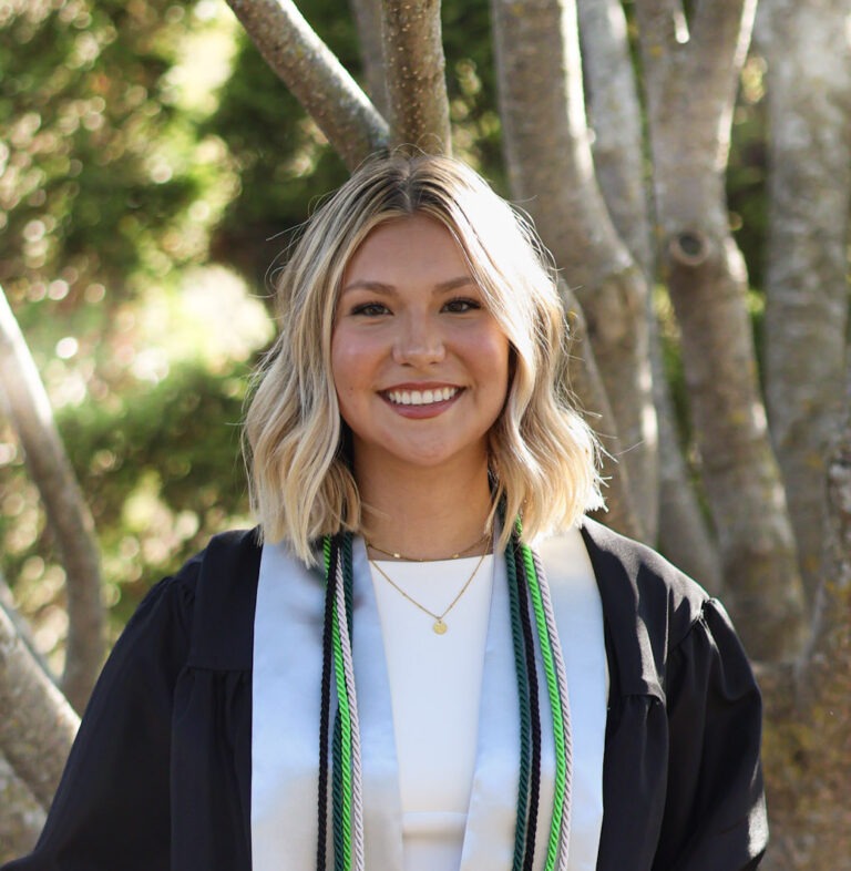 Olivia Kjorlien, Strategic Communications Associate at Four Leaf Communications, pictured at her UW-Green Bay graduation with honor cords.